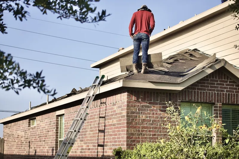 Professional roofer working on a residential roof in Montgomery Oaks